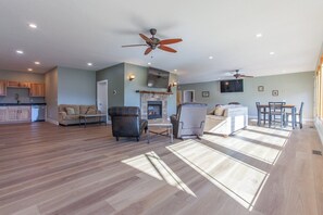 Cozy living area with fireplace, dining space, and high ceiling.