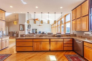 Enjoy cooking in this well-equipped kitchen with a large island, dishwasher, and ample storage.