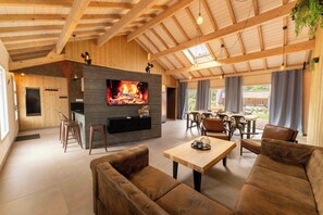 A spacious living area with a fireplace, comfortable seating, and a dining area with natural light.