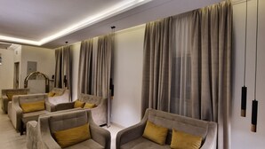 A modern living room with a sofa set and a large window with curtains. - Marin Suite Al-Badiah Serviced Apartments  (Riyadh)