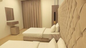 A modern hotel room with a large bed, a bedside table, a mirror, and a window with curtains. - Marin Suite Al-Badiah Serviced Apartments  (Riyadh)
