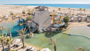 A resort with a water park, including slides and pools, set against a beach backdrop. - Cozy Oceanfront Resort Golf&SPA Suite Pacific Dunes San Lucas 4 p- 1 B./ 2 Bath (cabo san Lucas)