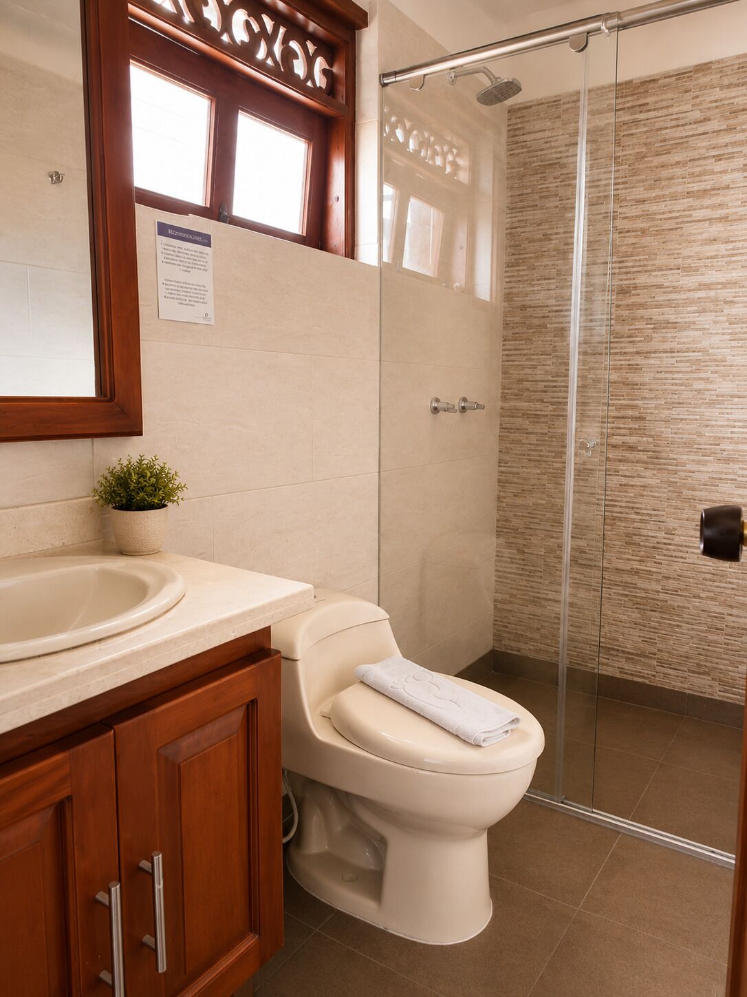 A bathroom with a toilet, sink, and shower.