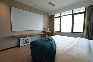 A hotel room with a bed, a large window with curtains, a wall-mounted TV, and a small table with a bottle and glasses. - Zhuzhou City Place. Yue Hotel (Zhuzhou)