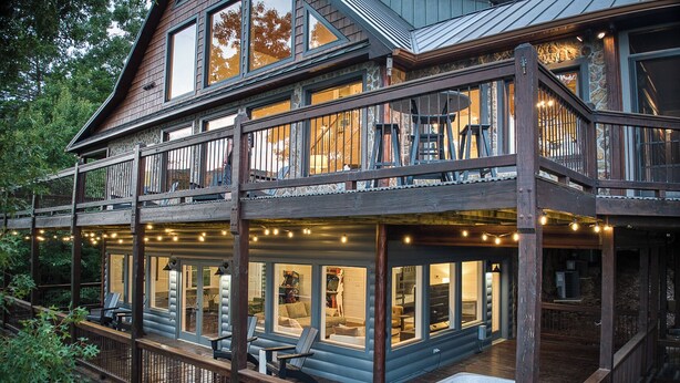 A two-story wooden cabin with a hot tub on the lower deck, large windows, and outdoor seating. - Breathtaking Views-Ping Pong-Video Games- Hot Tub (Blue Ridge)