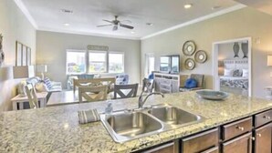 A kitchen with granite countertops, stainless steel sinks, and wooden cabinets. - D's by the Sea - 3 BR condo steps from the beach (Miramar Beach)