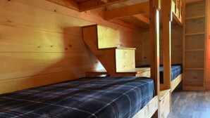 A wooden cabin with a bunk bed and a small dresser. - RT 62 Motor Resort Bunkhouse (Eureka Springs)