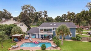 A two-story house with a backyard swimming pool, a covered patio, and a fenced yard. - Cleopatra's Sunset in Ocala (Ocala)