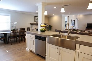 A modern kitchen with a dishwasher, a stainless steel sink, and pendant lighting. - Fantastic 6 bedroom 4 bath Pool Home (Anaheim)