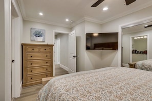 A bedroom with a bed, dresser, and a wall-mounted TV. - 5 Bedroom plus loft room, 3 Bath home (Fullerton)