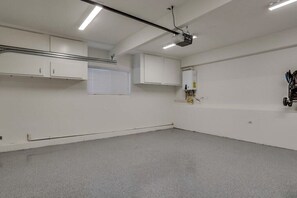 A room with white walls, a grey floor, and a ceiling-mounted projector. - 5 Bedroom plus loft room, 3 Bath home (Fullerton)