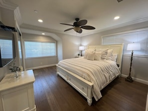 A bedroom with a bed, a ceiling fan, a dresser, and a window with blinds. - Fantastic 6 bedroom, 4.5 bath home (4 master Suites), pool home (Anaheim)