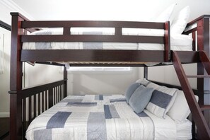 A bunk bed with a wooden frame, a quilted mattress, and pillows. - Incredible 5 Bedroom, 4 Bath, Rock Pool & Jacuzzi Home, 1/2 Mile Walk To Disney (Anaheim)