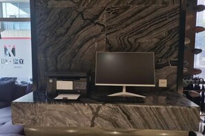 A desktop computer on a marble countertop with a printer and a keyboard. - LiSheng Yijia Hotel (Chengdu)