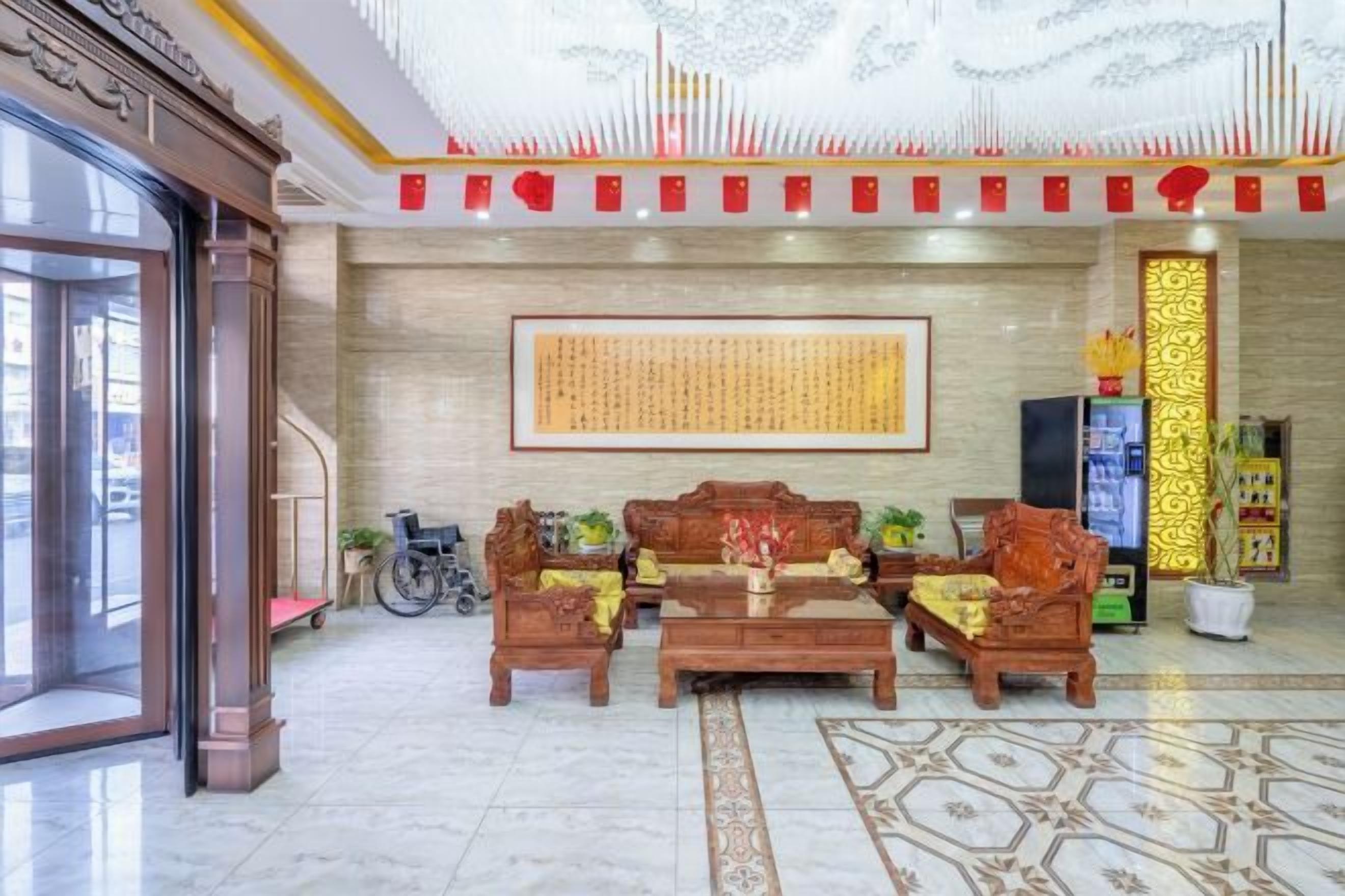 Una hall con reception, area salotto e un'ampia parete con calligrafia.