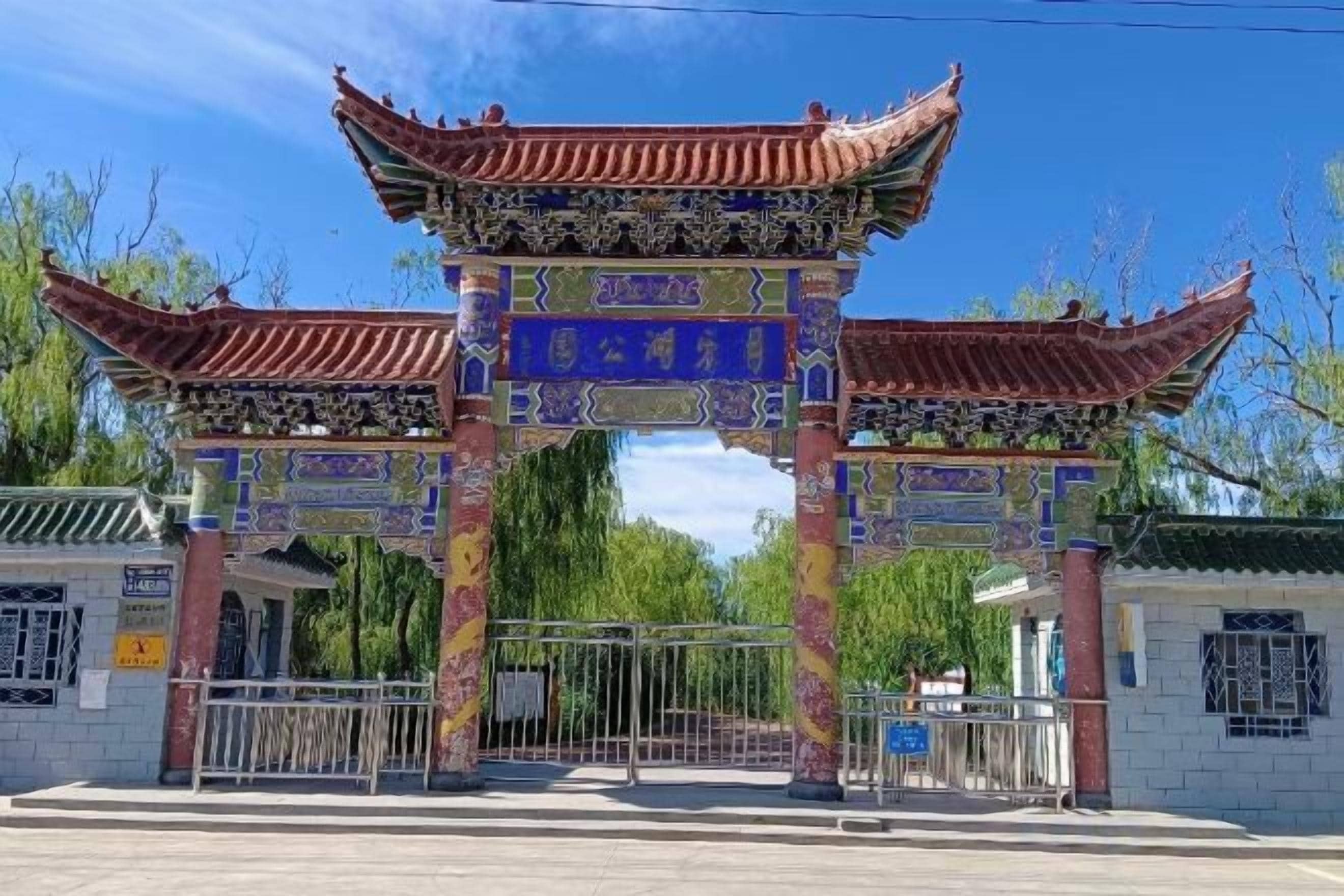 A traditional Chinese gate with intricate designs and a tiled roof.