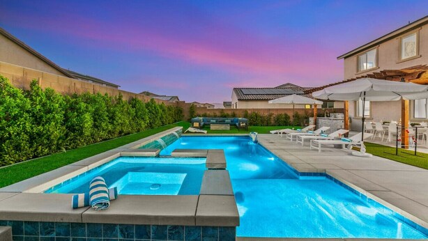 A swimming pool with a hot tub, lounge chairs, and a covered patio area. - 15 Bed, Glow Gameroom, Putting green, Pool & BBQ (Coachella)