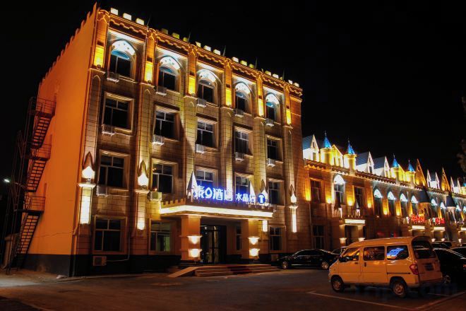 A multi-story building with a classic architectural style, featuring arched windows and decorative elements.