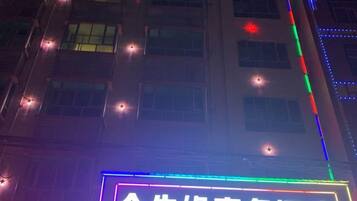 A building facade with illuminated signage and decorative lights.
