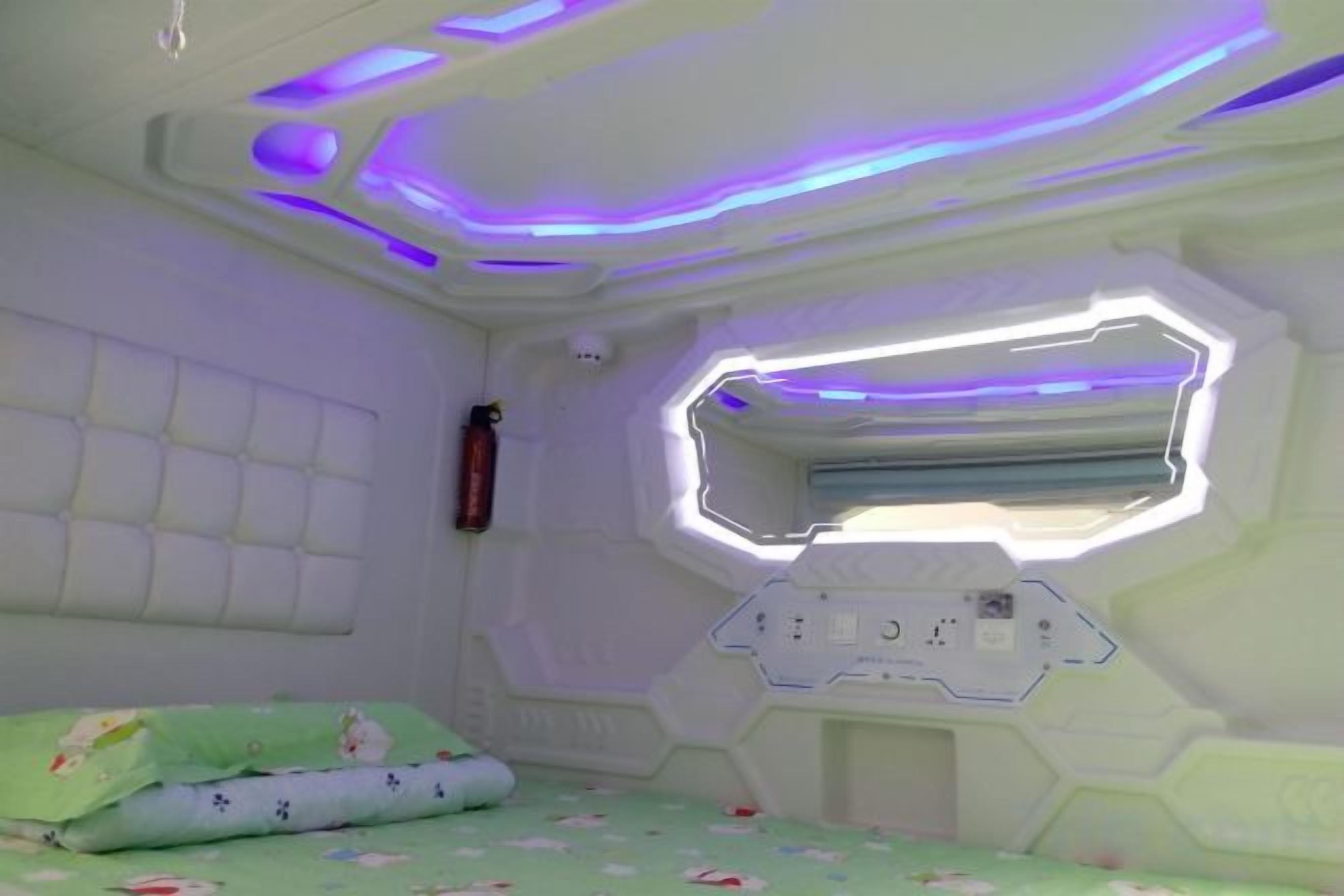 A room with a bunk bed, a window with a view, and a control panel.
