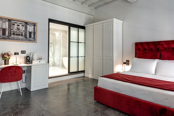 A bedroom with a bed, a desk, a chair, and a wardrobe.