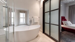 A modern bathroom with a freestanding bathtub, a glass shower enclosure, and a large window. - Magia di Firenze - Maria (Firenze)