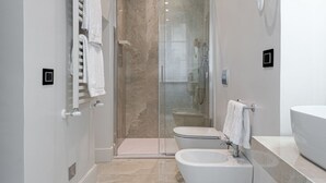 Een douche, een haardroger, een bidet, handdoeken
