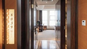 A hotel corridor with a reception desk, a dining area, and a view of the dining space. - Jiangyan Hotel (Taizhou)
