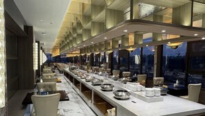 A long, elegant buffet area with marble flooring and modern lighting. - Jiangyan Hotel (Taizhou)