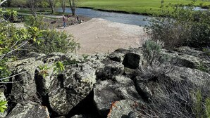 A natural landscape with a river, rocky terrain, and a grassy field. - Lost Trail Resort (Lava Hot Springs)