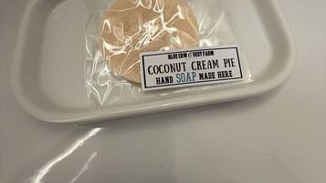 A hand soap package labeled 'Blue Cow & Guest Farm Coconut Cream Pie Hand Soap Made Here' on a white tray.
