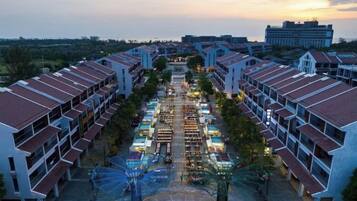 A hotel with multiple buildings, a central courtyard, and a view of the surrounding area.