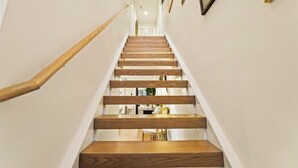 A wooden staircase with white walls and a handrail on the left. - French Country Cottage in lovely Glen Ellyn! (Glen Ellyn)