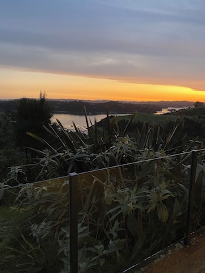 A view of a lake at sunset with a fence in the foreground. - Russell's Secluded Secret (Russell)