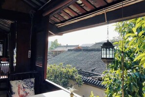 A traditional Japanese-style room with tatami flooring, a low table, and a hanging lantern.