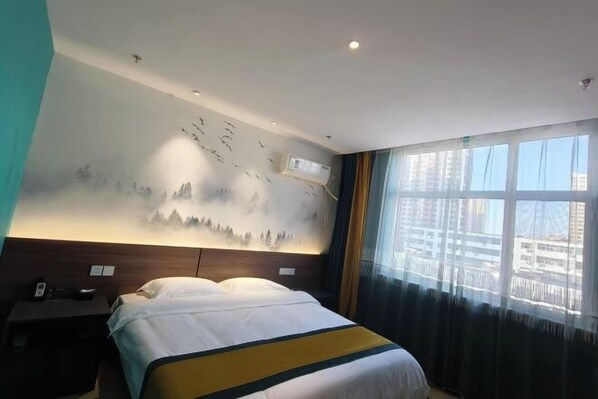 A hotel room with a bed, a nightstand, a wall mural, an air conditioning unit, and a large window with curtains.
