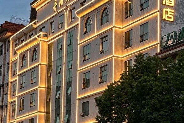 A multi-story hotel building with illuminated windows and a visible sign indicating it is a hotel. - Danyang Hotel (Guiyang)