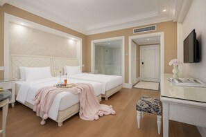 A hotel room with a large bed, a bedside table, a TV, and a bathroom door. - Yiju Haoting Hotel (Shangri-La)