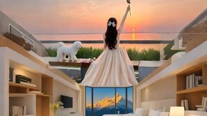 A modern hotel room with a large bed, a desk, and a view of a sunset over the water. - Yiju Haoting Hotel (Shangri-La)
