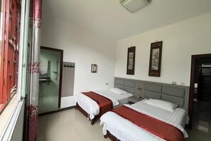 A hotel room with two single beds, a bathroom with a glass door, and a small desk with a chair. - Zhenyuan Yishan Yishui River View Homestay (Zhenyuan County)