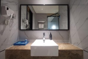 A bathroom with a white sink, a mirror, a hairdryer, and a towel rack. - Aste Meitu Hotel (Cultural Plaza Branch) (Yulin)