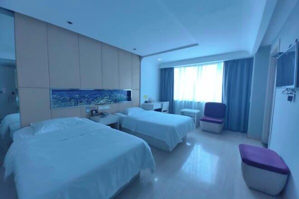 A hotel room with two beds, a small table, a chair, and a large window with curtains. - fuerte-hotel (Yueqing)