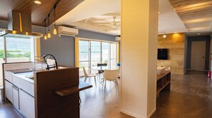 Enjoy meals and drinks at the central island with sink, or relax in the dining area with a round table and two chairs.