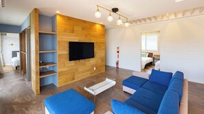 Relax in this stylish living room with a flat-screen TV, comfortable sofas, and a coffee table.