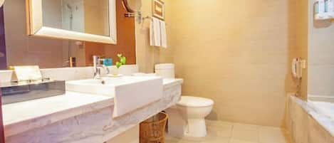 A modern bathroom with a large mirror, two sinks, a toilet, and a shower area.