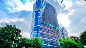 A modern high-rise building with the name "SAILING TOWER" prominently displayed.