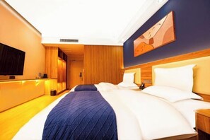 A hotel room with a large bed, a television mounted on the wall, and a wooden panel design. - Park Hyatt Fashion Hotel (Kaili cross street people's hospital） (Kaili)