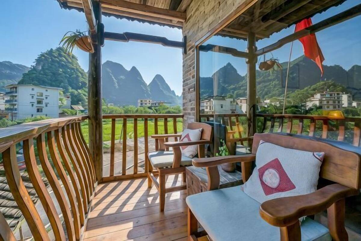 A wooden deck with a view of mountains and buildings.