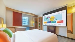 A hotel room with a bed, a desk, a chair, a TV screen, and a window. - Dongguan Qingxi E Hotel (Dongguan)