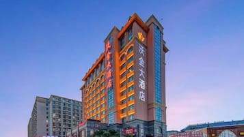 A multi-story hotel with a prominent entrance and signage.